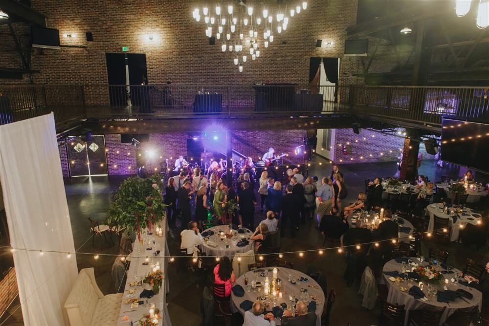Exposed brick, hardwood floors and chandeliers in Ironworks event space