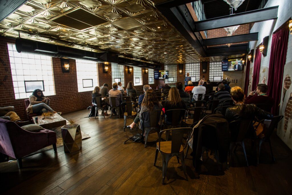 Guests seated for a presentation in the lounge area at Ironworks Denver